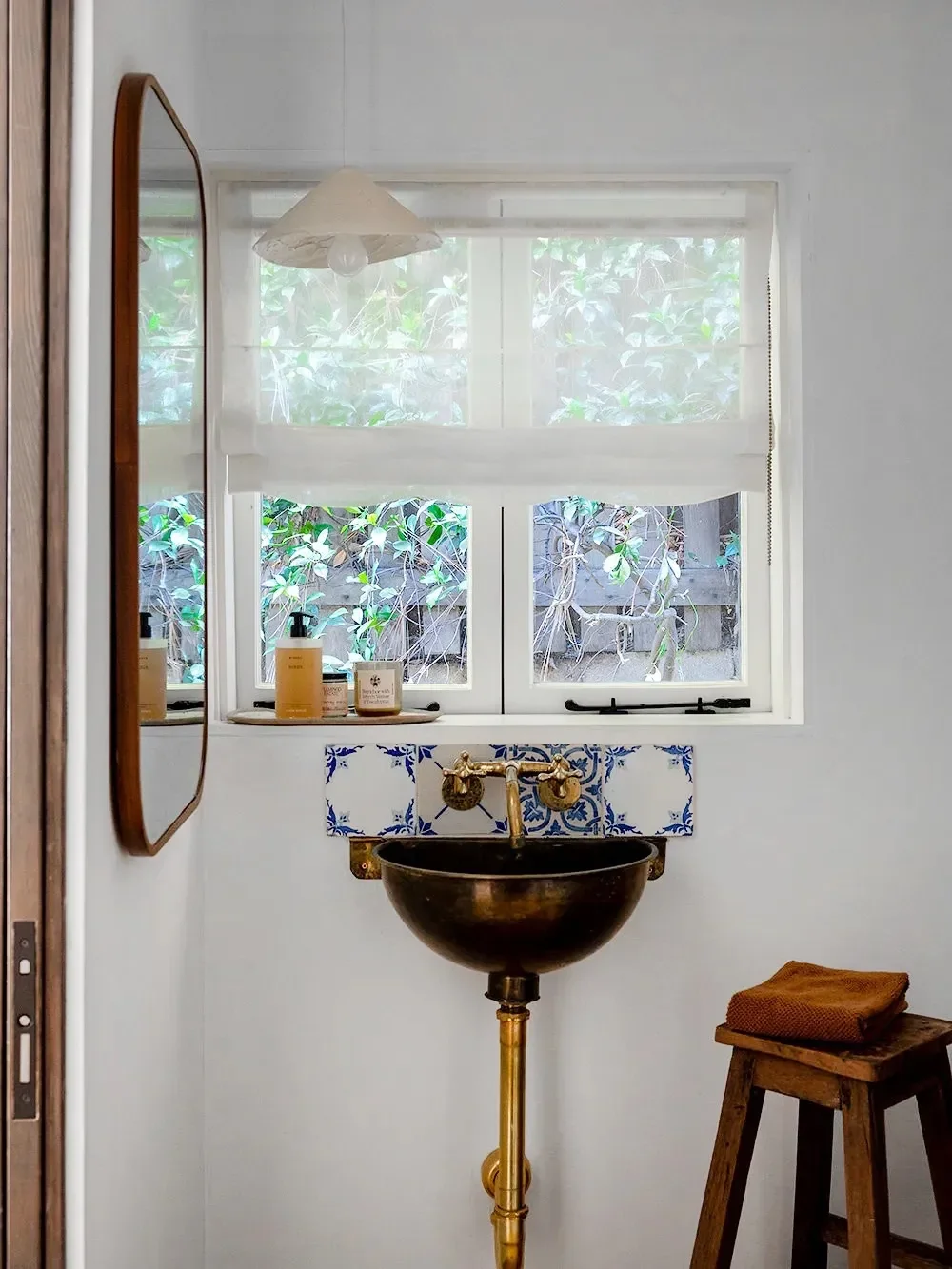 8 Bathroom Mirror Hacks for When a Window Keeps Cramping Your Style